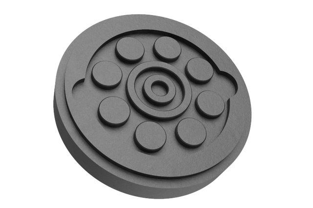 Front view of a black, round rubber pad with a rubber lip for slipping over the lift arm.