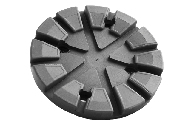 Front view of a black, round rubber pad (item no. 664000) for vehicle lifts, with four holes for bolting to the lift arm.